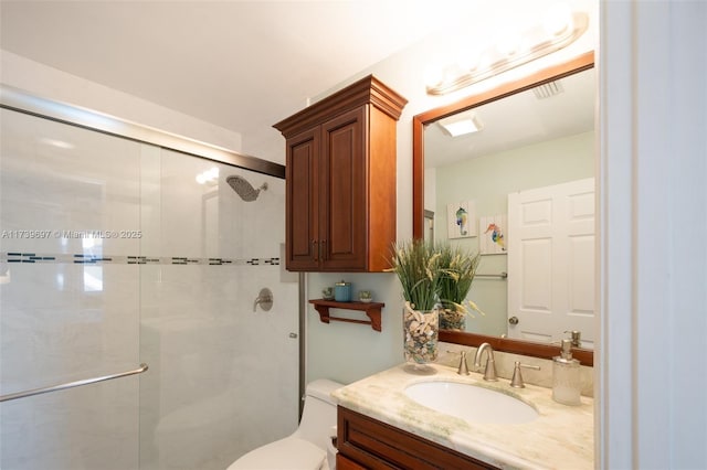 bathroom featuring walk in shower, vanity, and toilet