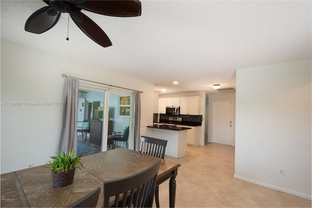 tiled dining room featuring ceiling fan