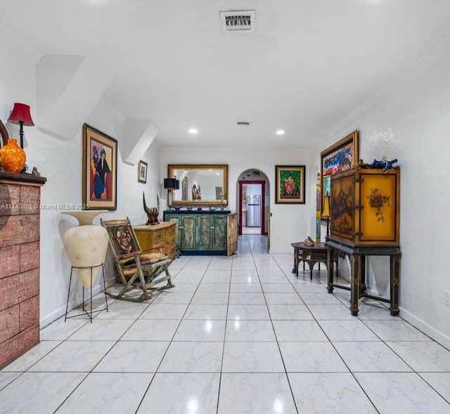 interior space featuring ornamental molding and light tile patterned floors