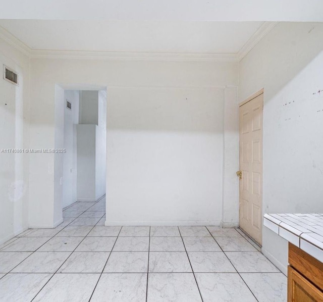 empty room featuring crown molding