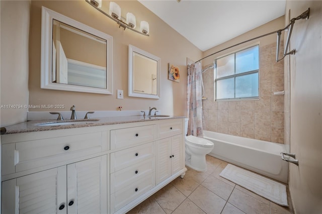 bathroom featuring toilet, double vanity, a sink, and shower / tub combo with curtain