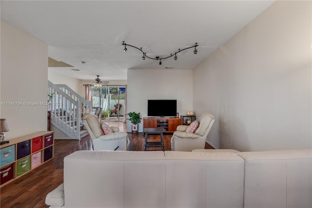 living area featuring ceiling fan, stairway, dark wood-style flooring, and rail lighting