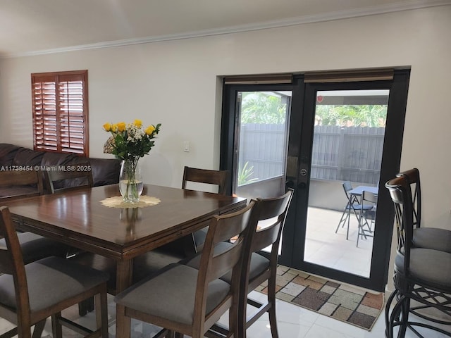 dining room featuring ornamental molding and french doors