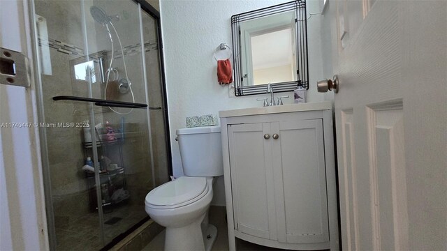 5051 NE 6th Ave, Deerfield Beach, FL 33064 - bathroom with vanity, a shower with shower door, and toilet