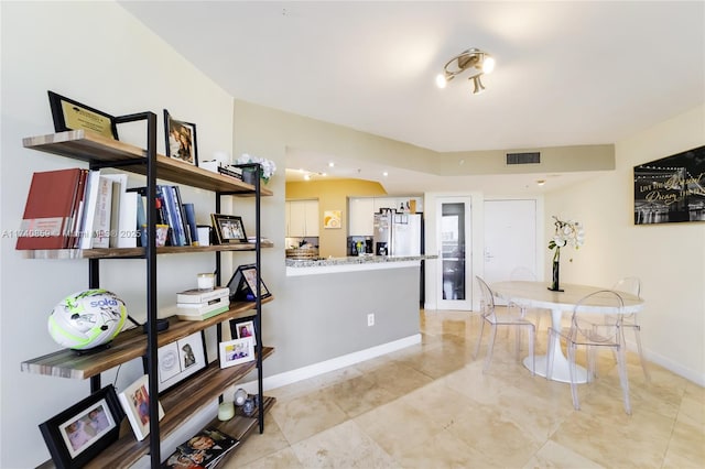 kitchen with kitchen peninsula and stainless steel fridge with ice dispenser