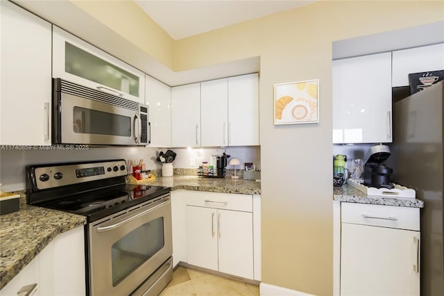 kitchen with white cabinetry, appliances with stainless steel finishes, and stone counters