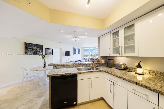 kitchen with sink, black dishwasher, light stone counters, white cabinets, and kitchen peninsula