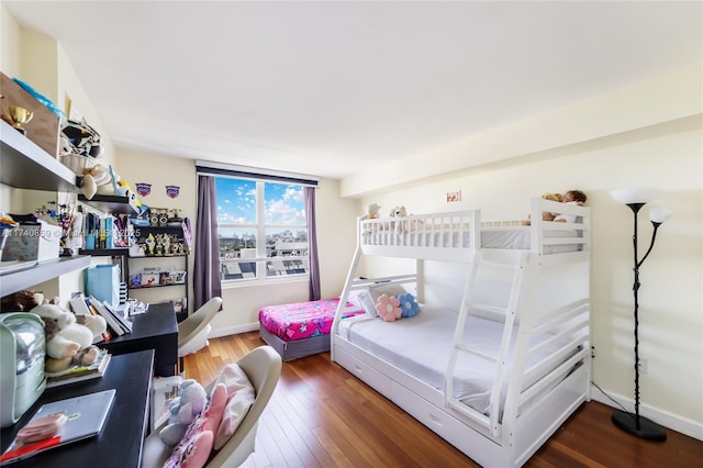 bedroom with dark hardwood / wood-style flooring