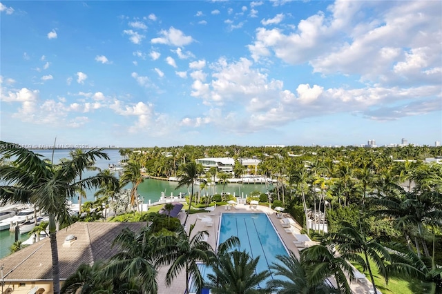 view of swimming pool featuring a water view and a patio area