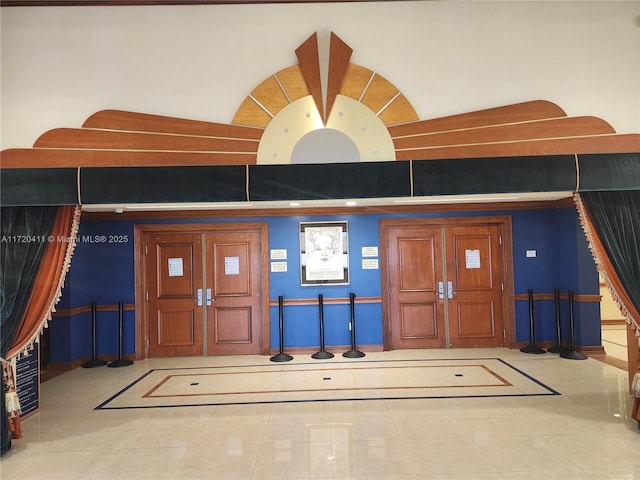 tiled foyer entrance with a towering ceiling