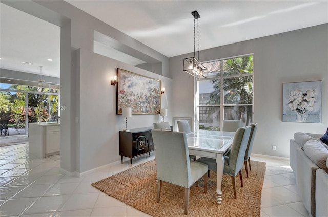 dining room featuring an inviting chandelier, plenty of natural light, and light tile patterned floors