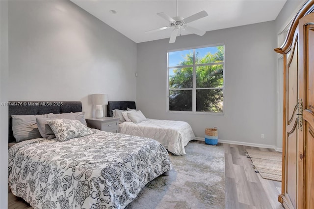 bedroom with vaulted ceiling, hardwood / wood-style floors, and ceiling fan