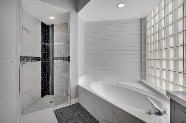 bathroom with separate shower and tub