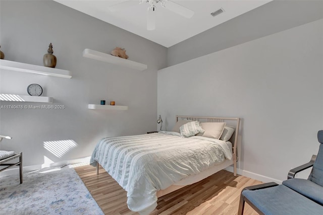 bedroom with hardwood / wood-style flooring and ceiling fan