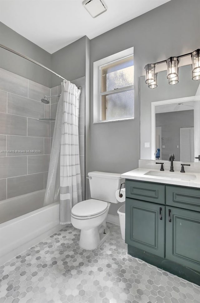 full bathroom with vanity, toilet, and shower / bath combo with shower curtain