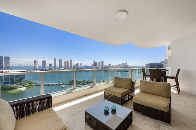 balcony featuring an outdoor hangout area, a water view, and a city view