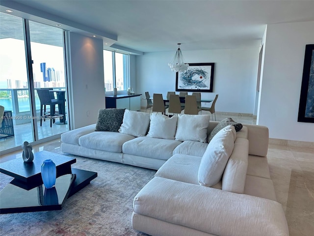 living room with an inviting chandelier and floor to ceiling windows