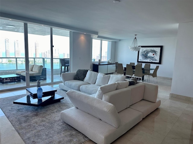 living room featuring an inviting chandelier and floor to ceiling windows