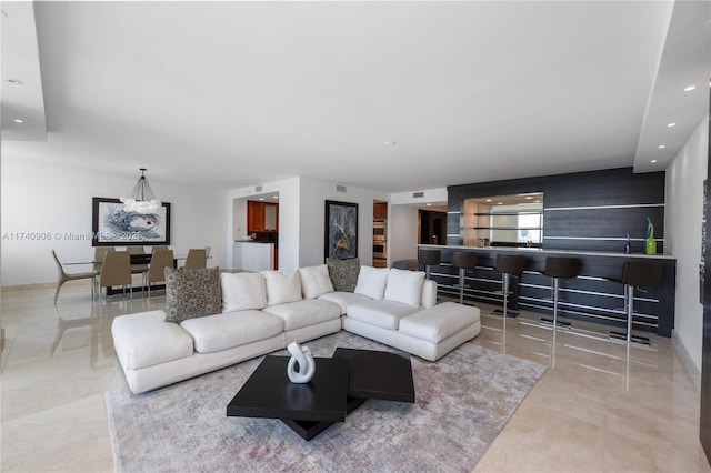 living area featuring recessed lighting and bar