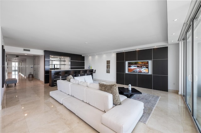 living area featuring marble finish floor, visible vents, and recessed lighting