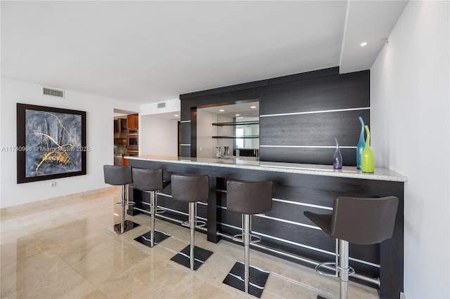 bar featuring recessed lighting, marble finish floor, visible vents, and a dry bar