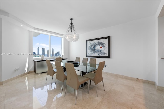 dining space featuring baseboards, a city view, and a notable chandelier