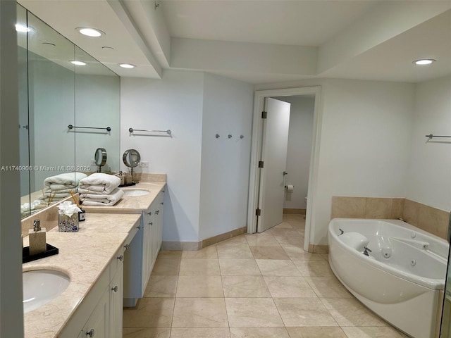 bathroom featuring vanity, tile patterned floors, and a tub to relax in