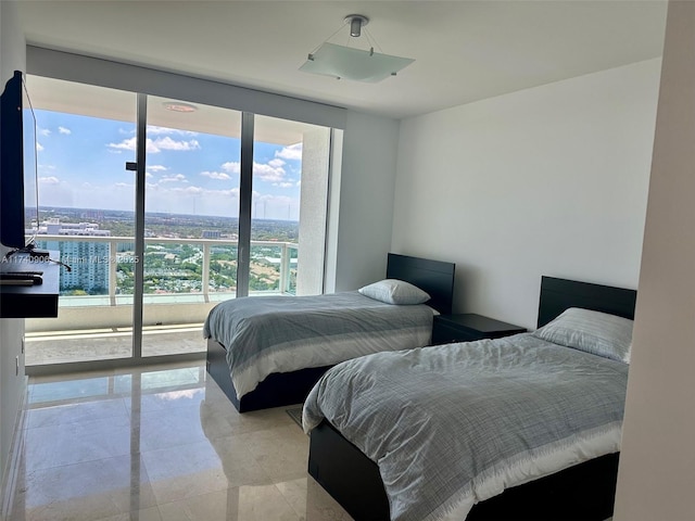 bedroom with a wall of windows and access to exterior