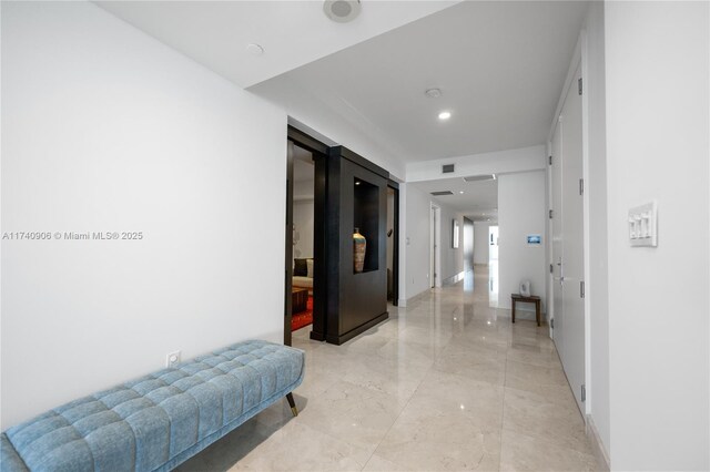 hall with marble finish floor