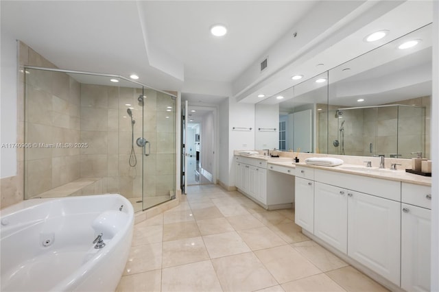 full bath with double vanity, a stall shower, visible vents, a tub with jets, and a sink