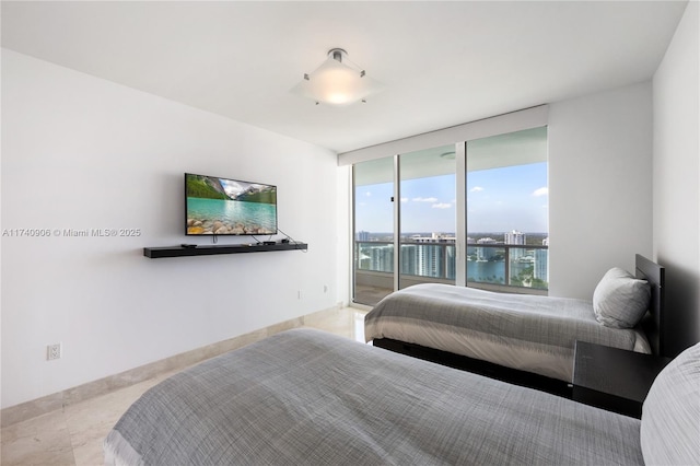 bedroom with baseboards and access to exterior