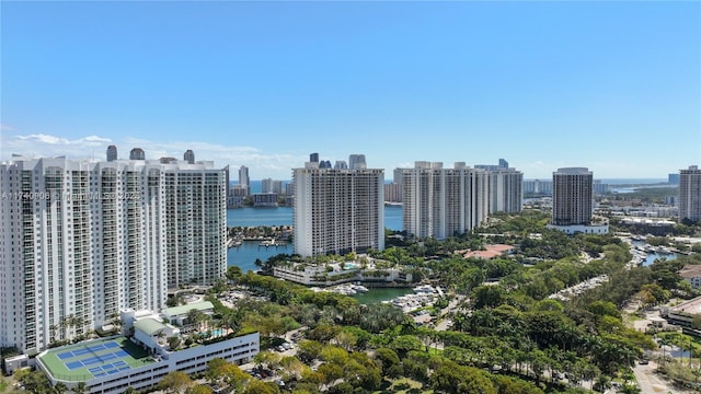 birds eye view of property with a water view and a city view