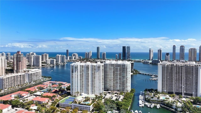 birds eye view of property with a view of city and a water view