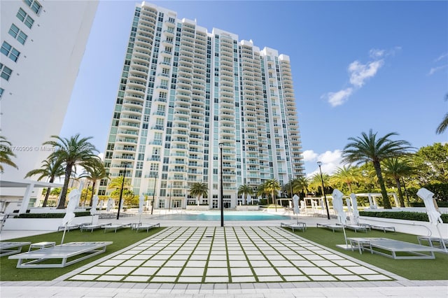 view of building exterior featuring a community pool