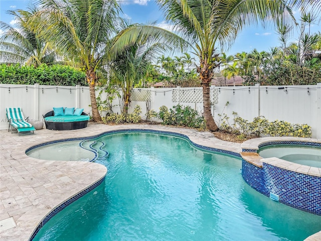 view of pool featuring an in ground hot tub and a patio