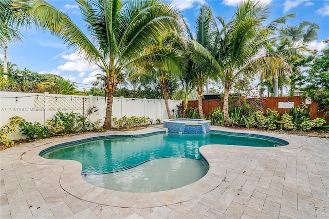 view of swimming pool featuring a patio and an in ground hot tub