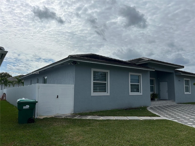 view of side of home with a yard