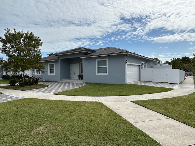 view of front of home with a garage and a front lawn