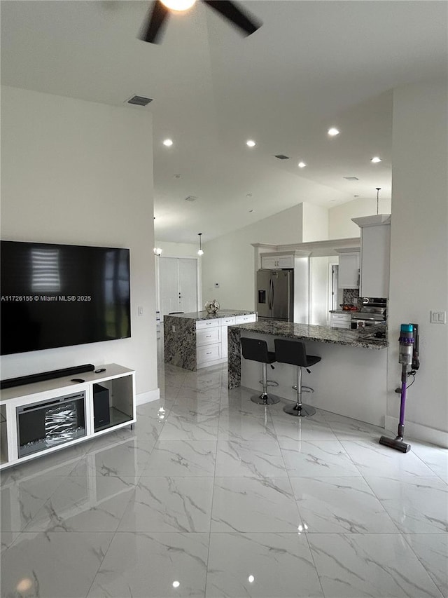 living room with vaulted ceiling and ceiling fan