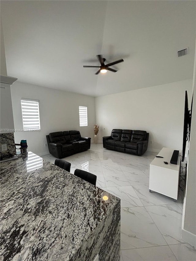 interior space with ceiling fan