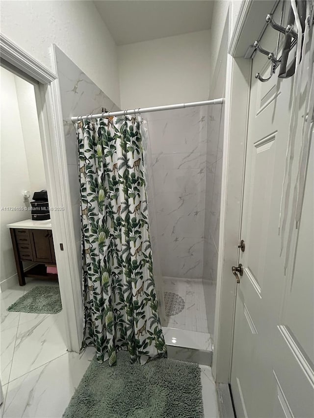 bathroom with walk in shower and vanity