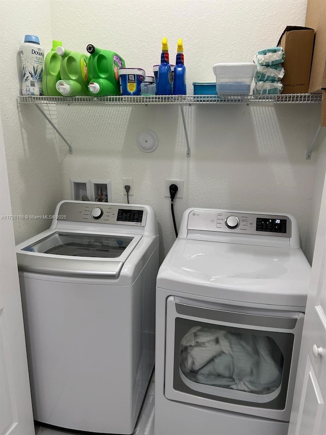 clothes washing area with independent washer and dryer