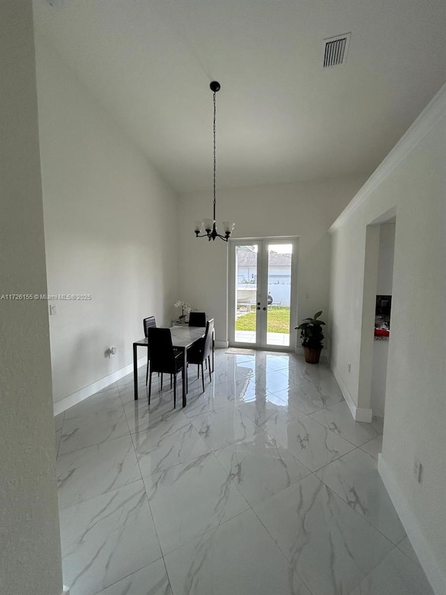 unfurnished dining area featuring an inviting chandelier and french doors