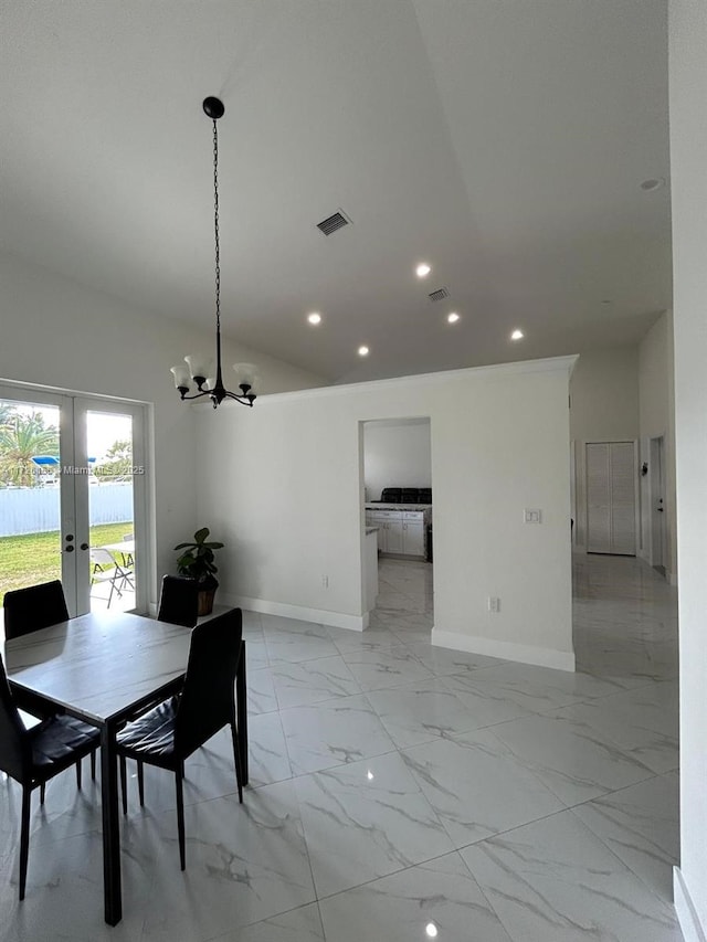 dining space featuring a notable chandelier and french doors