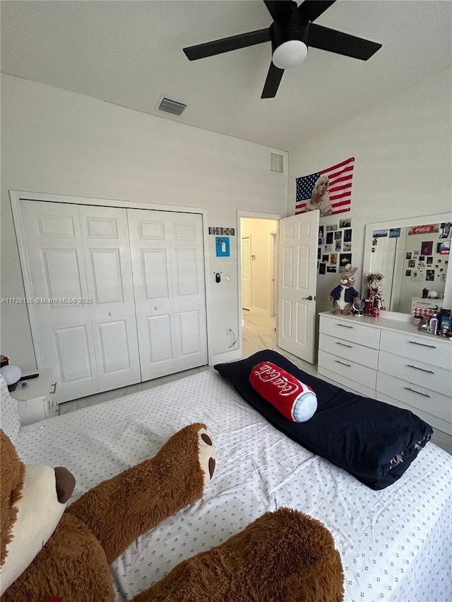 carpeted bedroom with ceiling fan and a closet