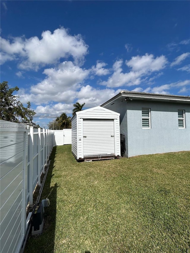 exterior space featuring a lawn and a storage shed