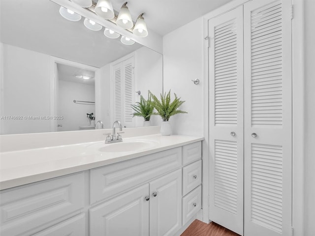 bathroom with hardwood / wood-style flooring and vanity