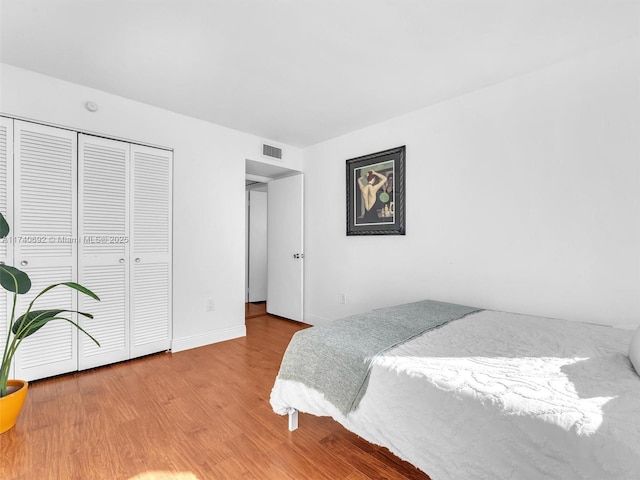 bedroom featuring light wood-type flooring and a closet