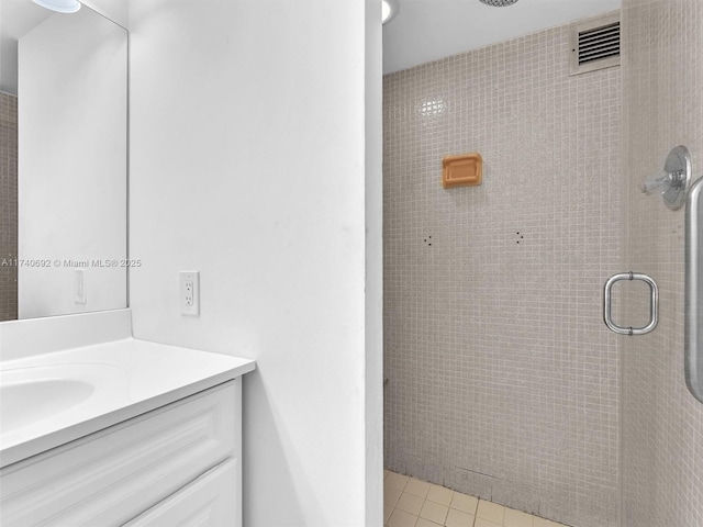 bathroom with vanity, tile patterned floors, and a shower with door