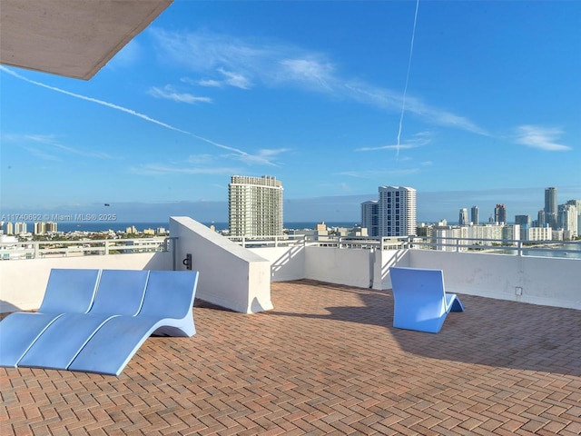 view of patio with a balcony and a water view